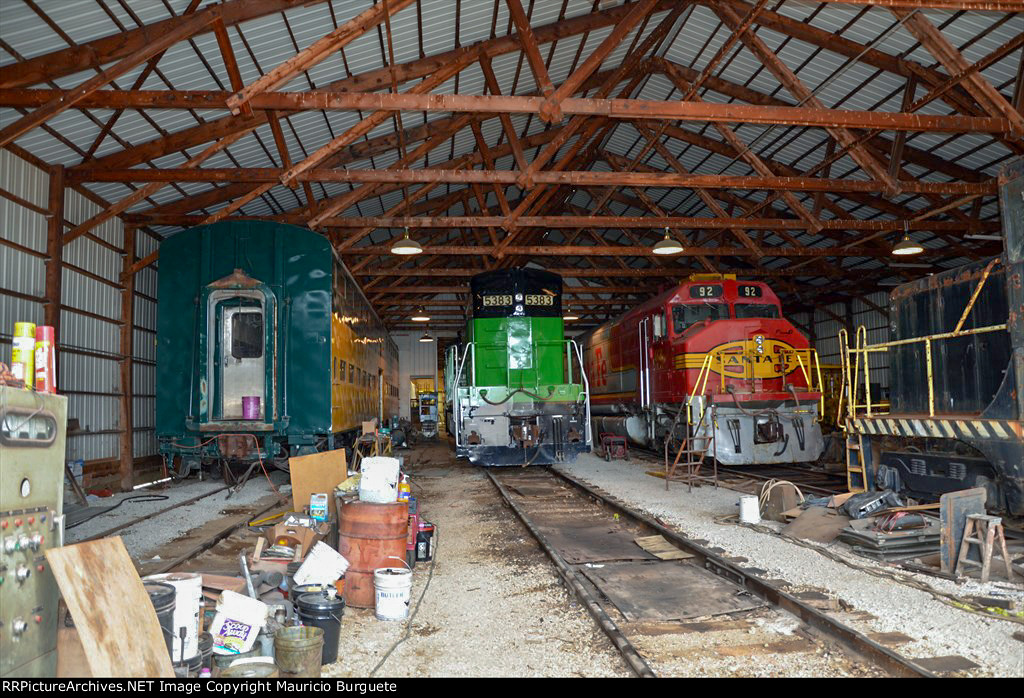 Diesel locomotives inside the barn and a CNW Cab car 